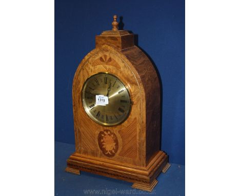 An unusual reproduction Bracket Clock having inlaid decoration to the Gothic arch shaped front of the case and having a quart