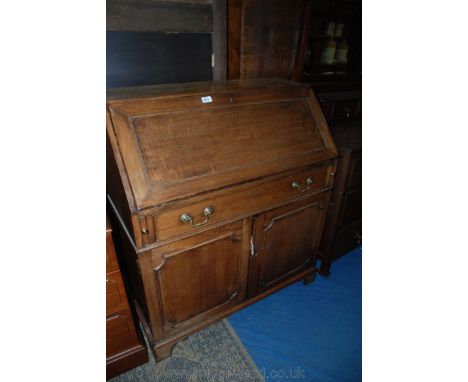 A circa 1920 Mahogany Georgian style Bureau with plain top, the cleated fall opening to reveal twelve pigeonholes and central