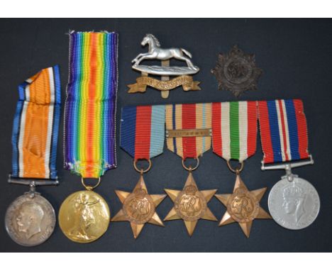 World War I pair of medals awarded to 4572 Pte E Parkin West Yorks Regiment along with cap badge and bar with four World War 