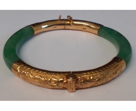 Tested as 18ct gold Chinese hinged jade bangle / bracelet.&nbsp;The bracelet of round form with gold hinge section and clasp 