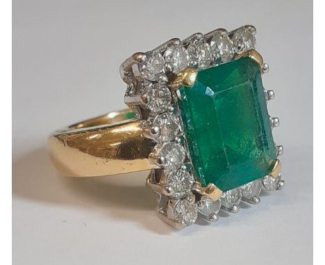 Impressive 18ct gold emerald &amp; diamond cluster ring with central rectangular emerald approximately 4.50ct surrounded by 1