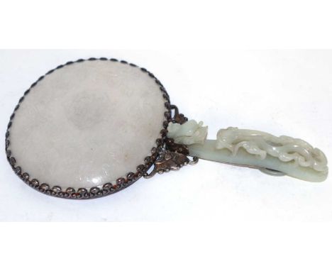 An 18th century Chinese white jade plaque, with 19th century silver mount and a celadon jade belt hook handle formed as a dre