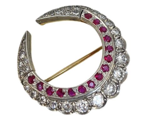 A Diamond and Ruby Double Crescent Brooch, circa 1950,mounted in white and yellow gold.
