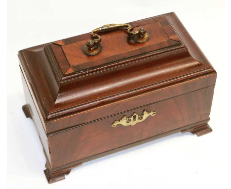 A Georgian mahogany tea caddy with pewter canisters, with a central brass carrying handle and shaped brass escutcheon to the 