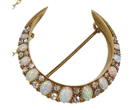 A Victorian Opal and Diamond Cresent Brooch, circa 1890,the eleven graduated oval shaped opals each spaced with two graduated