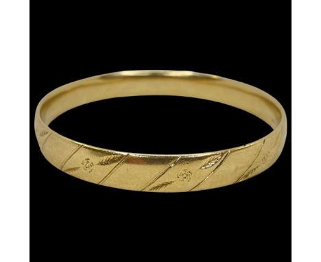 A Heavy 9ct Yellow Gold Bangle,embossed with floral decoration, weighing approximately 46g.