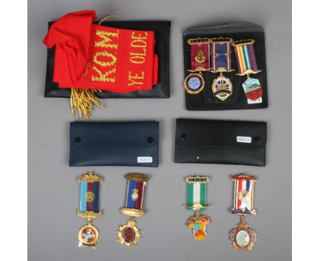 A collection of Royal Antediluvian order of buffaloes (RAOB) medals on ribbons, along with a K.O.M Ye Olde Vulcan Lodge sash.