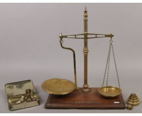 A set of W.T. Avery balance scales and weights along with a collection of brass bell weights.