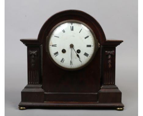 A mahogany mantle clock with French movement chiming on a coiled gong with pendulum and key.