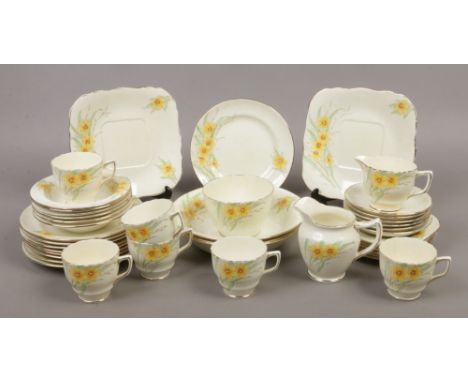 A Delphine china part teaset decorated with flowers to include cup and saucers, plates, milk jug etc.