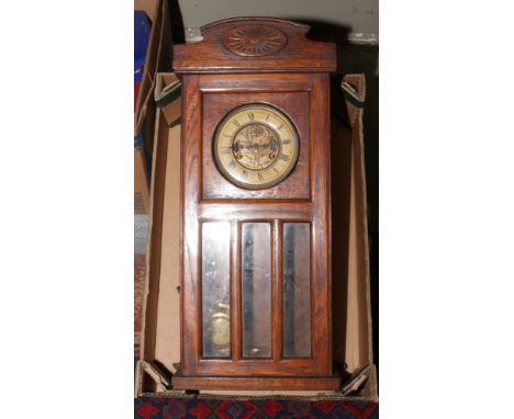 A carved oak wall clock with Roman numeral markers, chiming on a coiled gong.Condition report intended as a guide only.For re