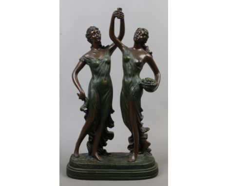 A bronzed composite mystery clock base formed as two classical maidens.