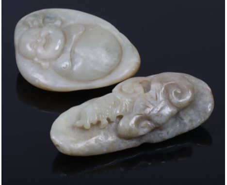 Two jade coloured boulders one carved with a Buddha, the other a mythical beast.