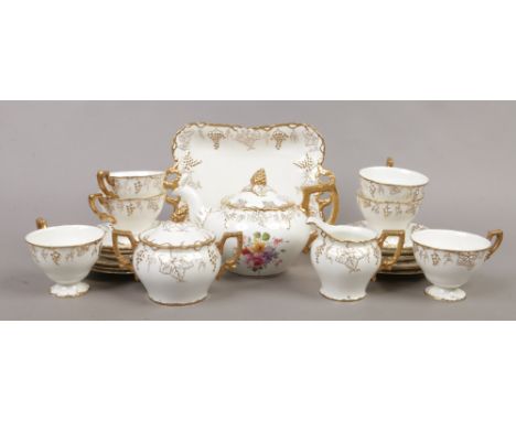 A Royal Crown Derby porcelain six place tea set in the 'Vine' design including teapot, sucrier, milk jug, sandwich plate and 