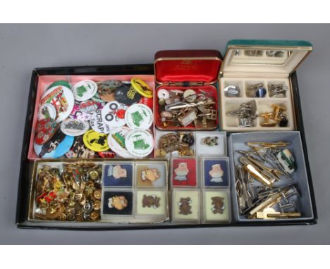 A tray of miscellaneous cufflinks, tie pins, badges and enamel pin badges etc.