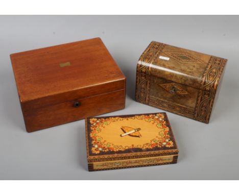 A Victorian figured walnut dome top tea caddy, along with a brass inlaid mahogany writing slope and a continental cigarette d