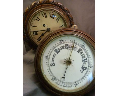 Oak 'rope detailed' Enamel faced clock with key and a similar barometer with coloured dial.