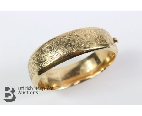 9ct hallmarked gold bangle, with floral engraving, 62mm diameter, approx 24.8 gms.&nbsp;

Note: slight dents to the surface.&