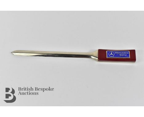 Mercedes Benz showroom letter opener/paper knife, plated finish with wooden handle and blue enamel Mercedes Benz logo. Appear