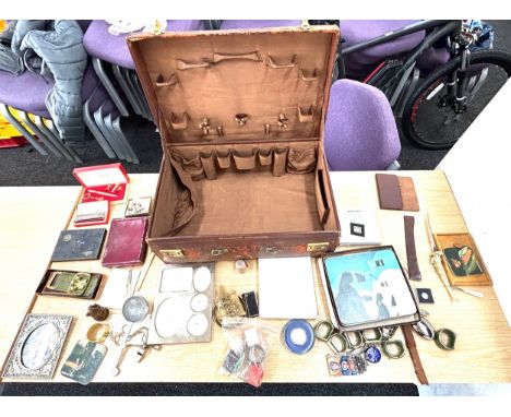 Vintage leather suitcase containing various collectables including 1970s Pirelli table mats, 1969 prince of Wales investiture