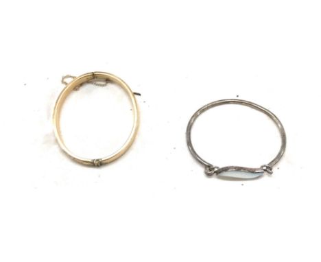 9ct gold metal core bangle and a silver stone set bangle