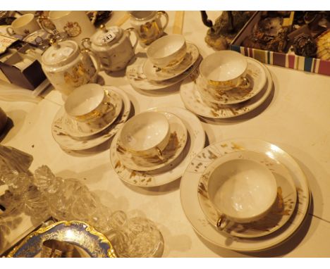 White porcelain Japanese tea service with gilt decoration and lithopane base 