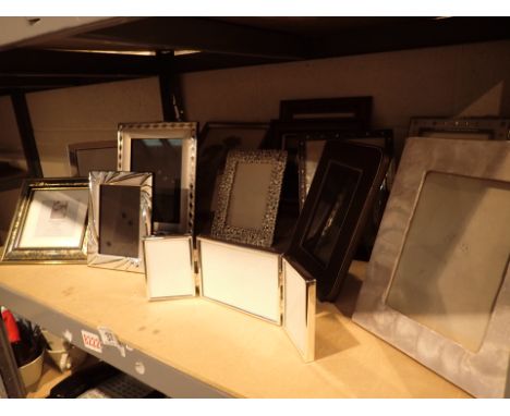 Shelf of empty photo frames brass chrome leather wood etc 