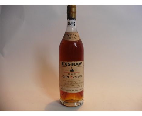 An old bottle of John Exshaw Grande Champagne Cognac Vintage 1935 specially bottled for Grosvenor House 70% proof no size sta