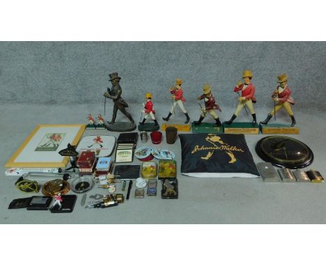 An extensive collection of Johnny Walker memorabilia and advertising items including vintage advertising statues, four hip fl