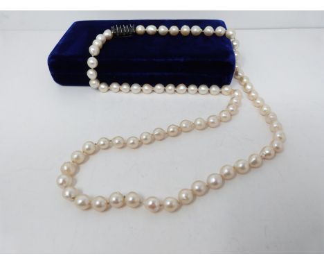 A vintage baroque cultured pearl necklace with an abstract white metal non opening clasp with brooch fitting. Seventy two whi