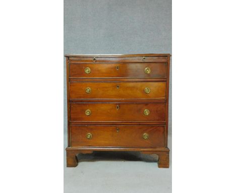 A Georgian mahogany chest of four long drawers fitted with brush slide on bracket feet. H.80 W.74 D.39cm 