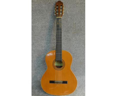 A vintage acoustic guitar by Santos Martinez. Model SM20. H.99cm 