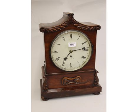 Early Victorian mahogany bracket clock, the shaped case with carved decoration, the circular painted dial with Roman numerals