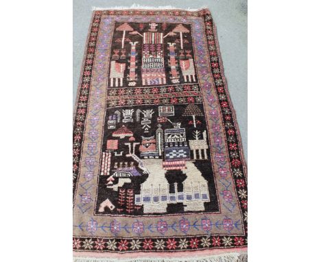 Belouch rug with two panel stylised design on a dark ground with borders, 6ft 4ins x 3ft 4ins approximately 