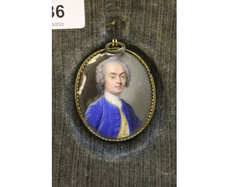 19th Century oval head and shoulder portrait miniature of a bewigged gentleman in blue velvet jacket, (porcelain at fault), i