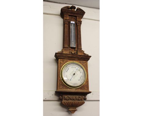 Late 19th / early 20th Century carved oak aneroid barometer thermometer by Negretti & Zambra, in architectural form case (the