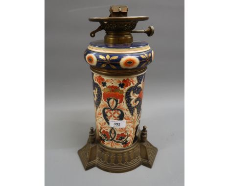 Victorian pottery and brass mounted oil lamp decorated in Imari colours together with a quantity of other oil lamp shades and