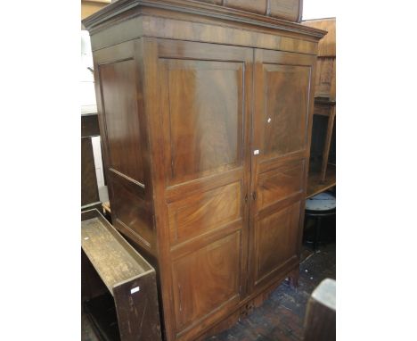 Early 19th Century mahogany wardrobe with two triple fielded panel doors enclosing hanging space, 53.5ins wide, 78ins tall 