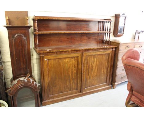 Large Victorian mahogany chiffonier, the double shelf back on turned supports, above two panelled doors on a plinth base, 70i