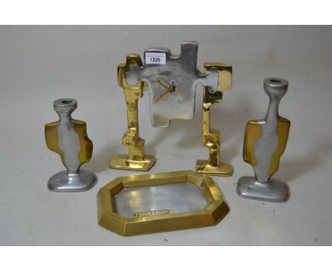 David Marshall (born 1942), brass and chrome mantel clock of sculptural form, signed, 10.25ins high together with two candles