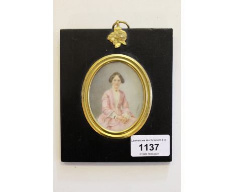 Late 19th / early 20th Century oval portrait miniature of a seated young lady, in a pink dress, signed A. Parguez, in an ebon