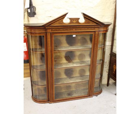 Edwardian mahogany and marquetry inlaid wall cabinet, the broken arch pediment above a glazed door enclosing velvet lined she