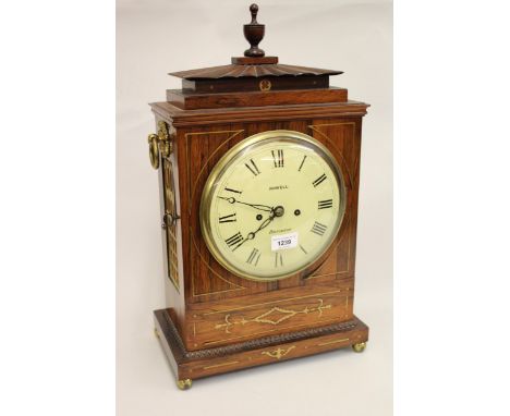 Regency rosewood and cut brass inlaid bracket clock, the pagoda case with brass ring handles and ball feet, the circular pain