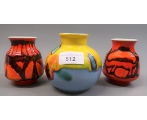 Poole pottery squat baluster form vase, in orange, yellow and mauve and two small Poole pottery vases with stylised decoratio