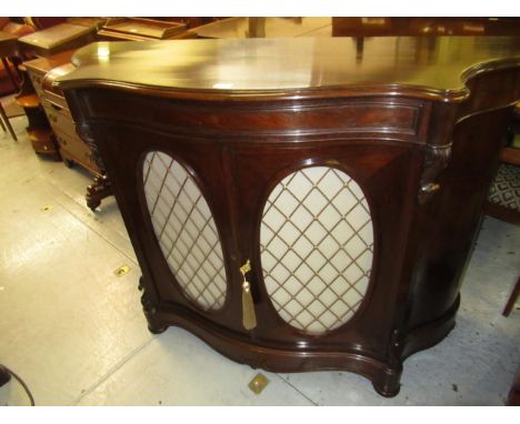 19th Century rosewood serpentine fronted side cabinet, the moulded top above a single drawer, with two oval brass grill panel