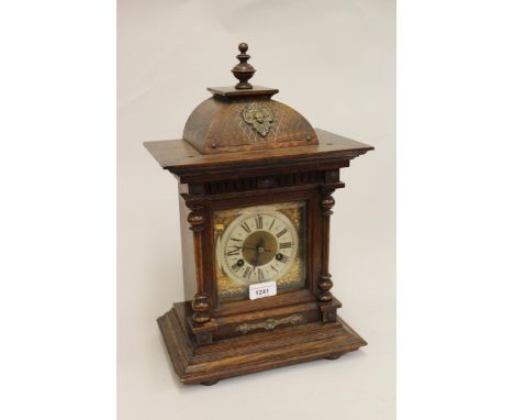 20th Century oak bracket clock, the brass dial, with silvered chapter ring, Roman numerals and two train movement, striking o