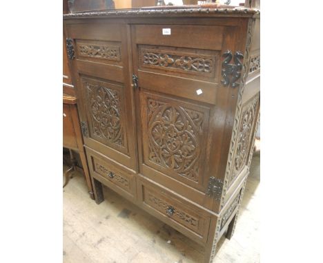 Late 19th / early 20th Century carved oak side cabinet (made up from earlier panelling), the carved cornice above a pair of p