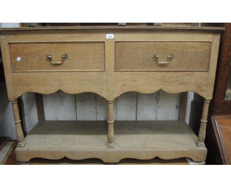 Small early 20th Century light oak dresser with a boarded shelf back above two drawers, turned supports and undertier, 48ins 