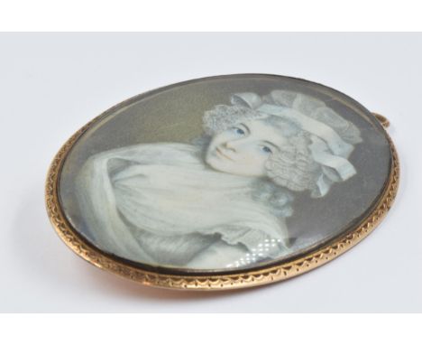 18th Century yellow metal brooch / pendant, inset with a hand painted portrait miniature of a lady wearing a lace bonnet, 65m
