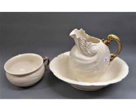 Early 20th Century shell form jug, basin and chamber pot decorated with clear lustre glaze, the jug with a gilt handle 